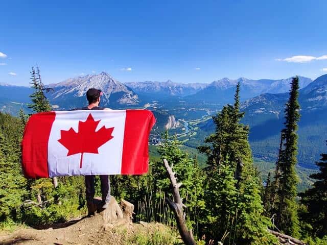 hiker holding a Canada flag