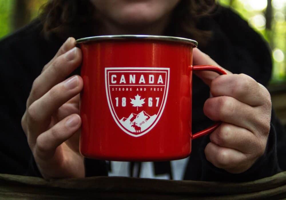 person holding a red mug